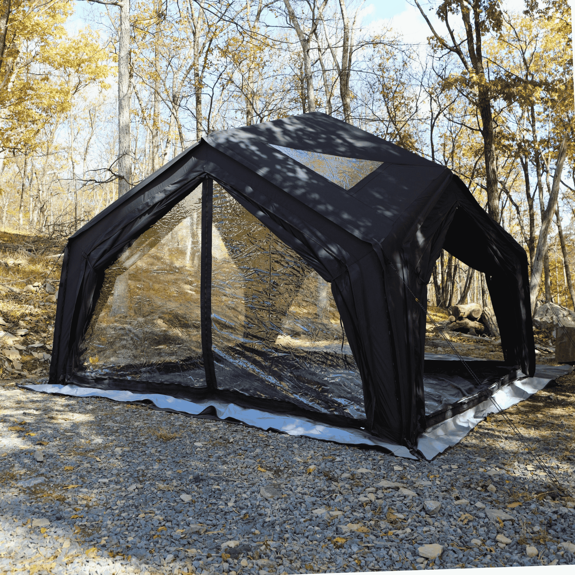 Black inflatable shelter in a forest setting