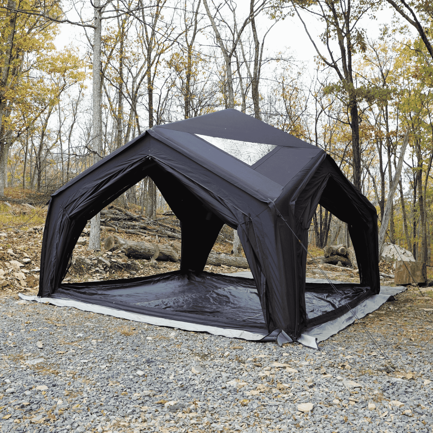 Black inflatable tent set up in a forested
