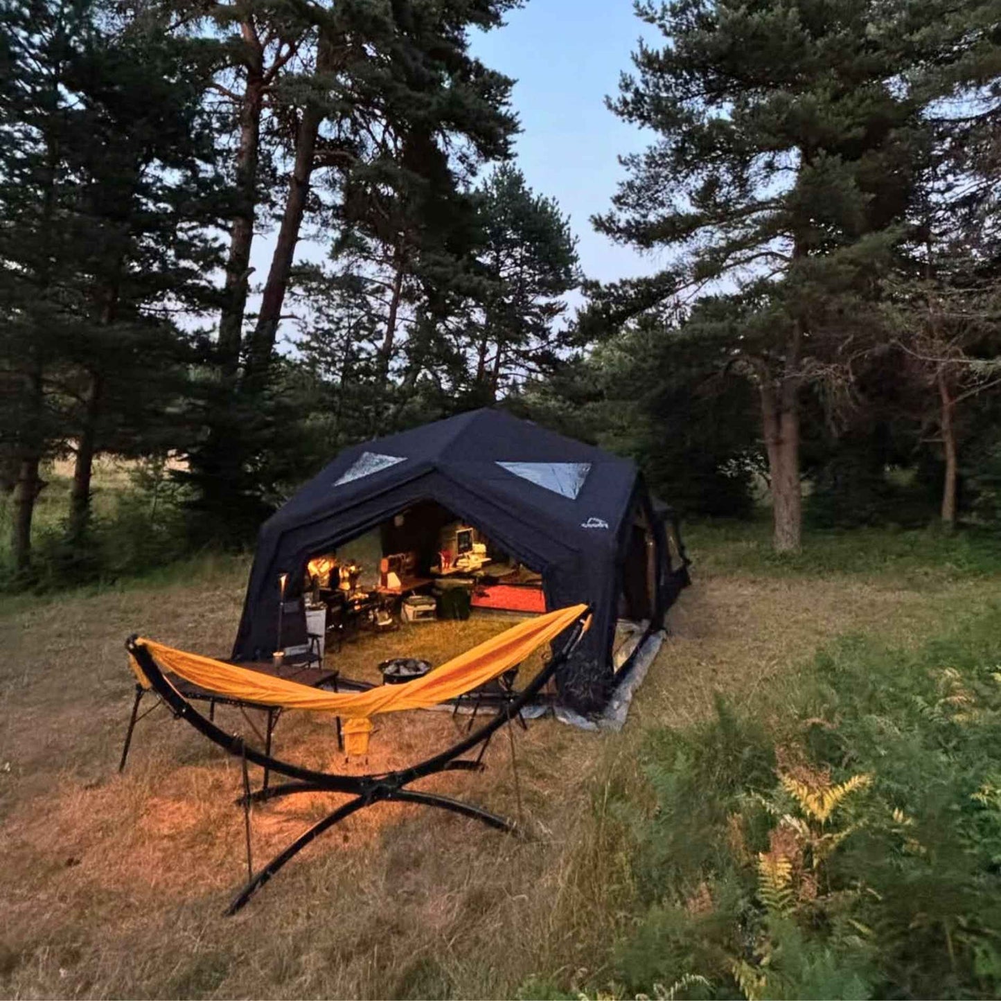 Camping setup with a black tent
